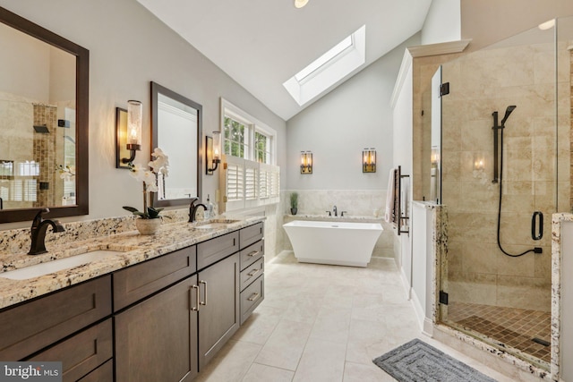 660 Casey Ln, West Chester, PA 19382 - full bathroom with vaulted ceiling, a stall shower, a skylight, double vanity, and a soaking tub