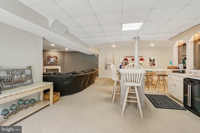 660 Casey Ln, West Chester, PA 19382 - living room featuring light colored carpet, a paneled ceiling, and bar area