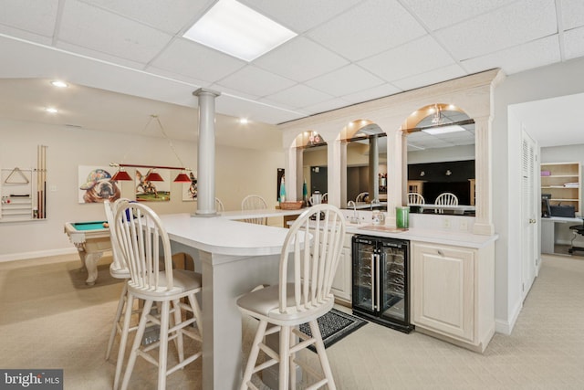 660 Casey Ln, West Chester, PA 19382 - kitchen with beverage cooler, light carpet, a breakfast bar, a paneled ceiling, and light countertops