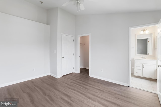 25154 Monteith Ter, Chantilly, VA 20152 - unfurnished bedroom featuring light wood-type flooring, ensuite bathroom, a walk in closet, a closet, and a ceiling fan