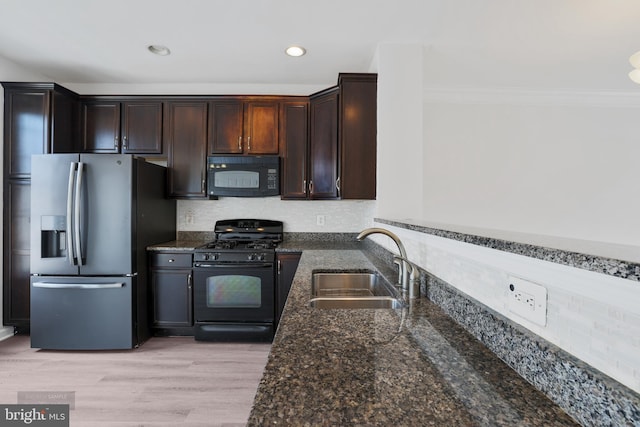 25154 Monteith Ter, Chantilly, VA 20152 - kitchen featuring black appliances, dark stone countertops, ornamental molding, dark brown cabinets, and tasteful backsplash
