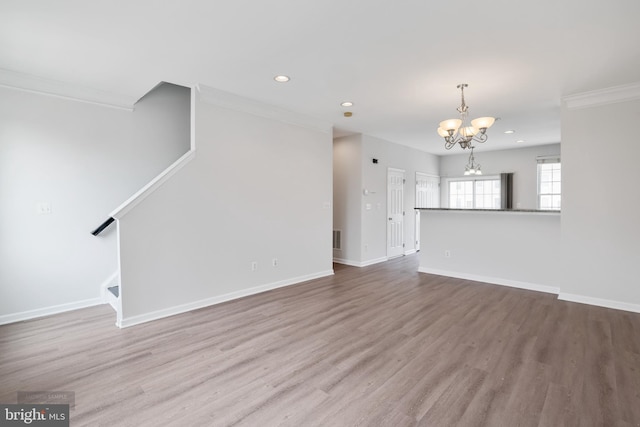 25154 Monteith Ter, Chantilly, VA 20152 - unfurnished living room with crown molding, a chandelier, recessed lighting, wood finished floors, and stairway