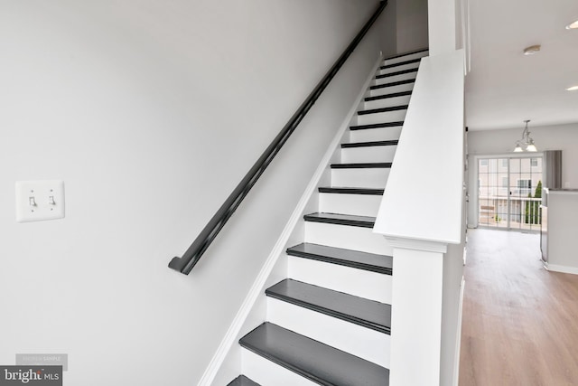 25154 Monteith Ter, Chantilly, VA 20152 - stairway featuring wood finished floors, a chandelier, and recessed lighting