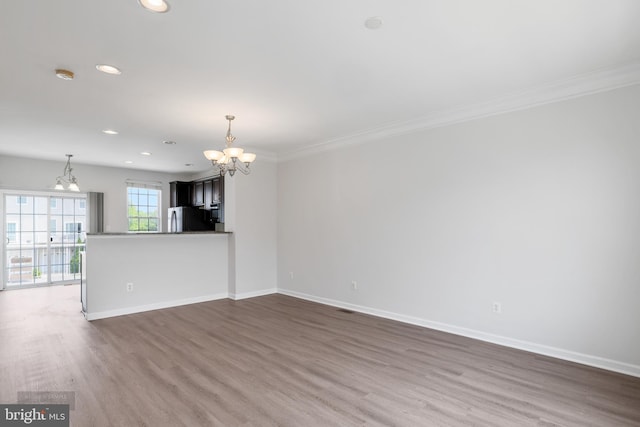 25154 Monteith Ter, Chantilly, VA 20152 - unfurnished living room with a chandelier, recessed lighting, ornamental molding, and dark wood-style flooring