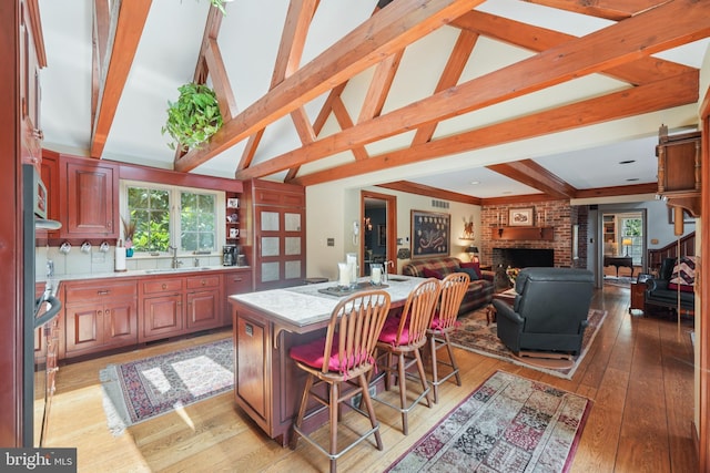 4250 Fretz Mill Rd, New Hope, PA 18938 - kitchen featuring healthy amount of natural light, a kitchen island, light wood finished floors, and a breakfast bar area