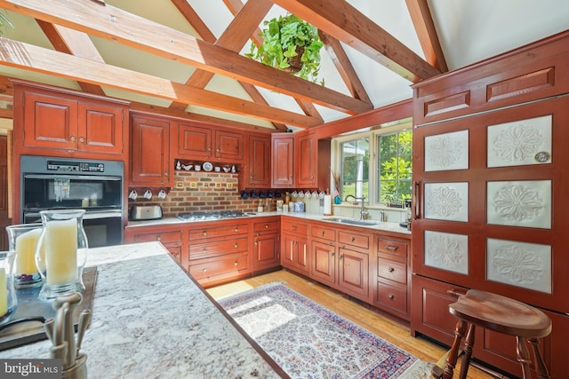 4250 Fretz Mill Rd, New Hope, PA 18938 - kitchen with stainless steel gas stovetop, beamed ceiling, light wood-type flooring, light stone countertops, and backsplash