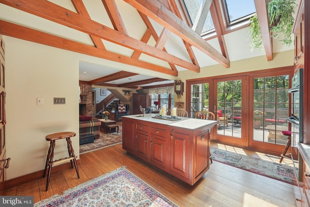 4250 Fretz Mill Rd, New Hope, PA 18938 - kitchen with open floor plan, beam ceiling, light wood-style floors, french doors, and a center island with sink