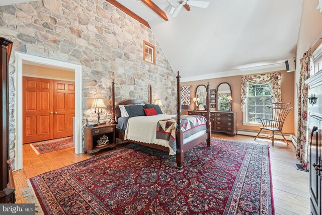 4250 Fretz Mill Rd, New Hope, PA 18938 - bedroom featuring wood finished floors, beam ceiling, baseboard heating, ornamental molding, and a wood stove