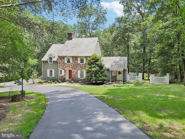 4250 Fretz Mill Rd, New Hope, PA 18938 - colonial house featuring a chimney, stone siding, and curved driveway