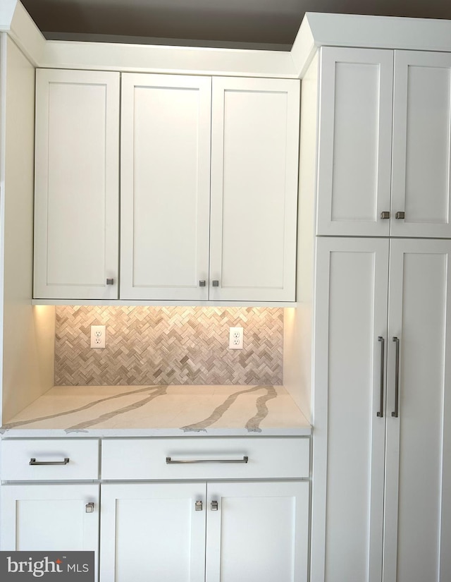 255 Jameson Way Unit 25, Wilmington, DE 19803 - kitchen with white cabinetry, light stone countertops, and decorative backsplash