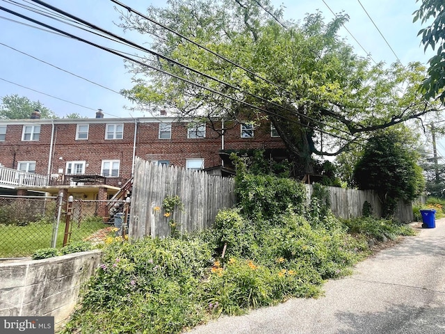 5501 W Forest Park Ave, Baltimore, MD 21207 - view of property exterior featuring brick siding and a chimney
