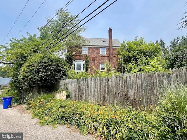 5501 W Forest Park Ave, Baltimore, MD 21207 - view of property exterior with a chimney and brick siding