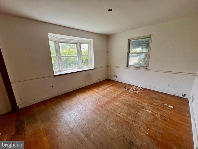 5501 W Forest Park Ave, Baltimore, MD 21207 - unfurnished room with plenty of natural light and wood finished floors