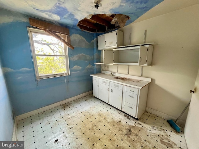 5501 W Forest Park Ave, Baltimore, MD 21207 - kitchen featuring white cabinetry, light countertops, and light flooring