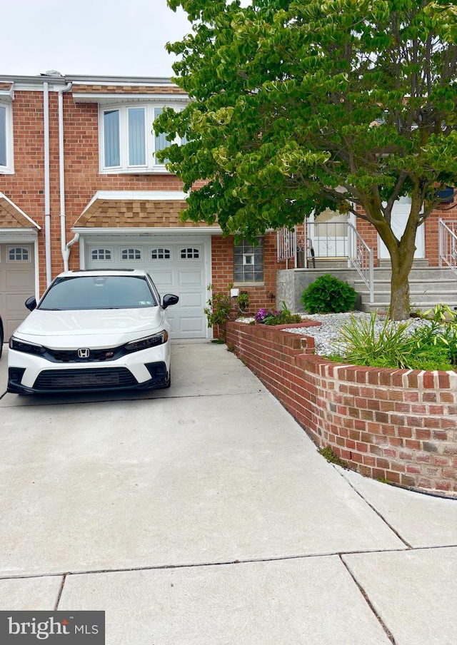 10826 Heflin Rd, Philadelphia, PA 19154 - view of front of house with concrete driveway, an attached garage, and brick siding