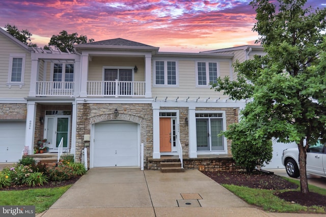 8804 Shining Oceans Way Unit 53, Columbia, MD 21045 - multi unit property featuring stone siding, concrete driveway, a balcony, and an attached garage