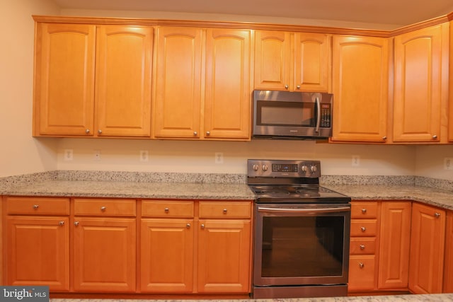 8804 Shining Oceans Way Unit 53, Columbia, MD 21045 - kitchen featuring appliances with stainless steel finishes and light stone counters