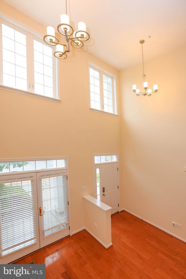 8804 Shining Oceans Way Unit 53, Columbia, MD 21045 - entrance foyer with a chandelier, plenty of natural light, wood finished floors, and a high ceiling