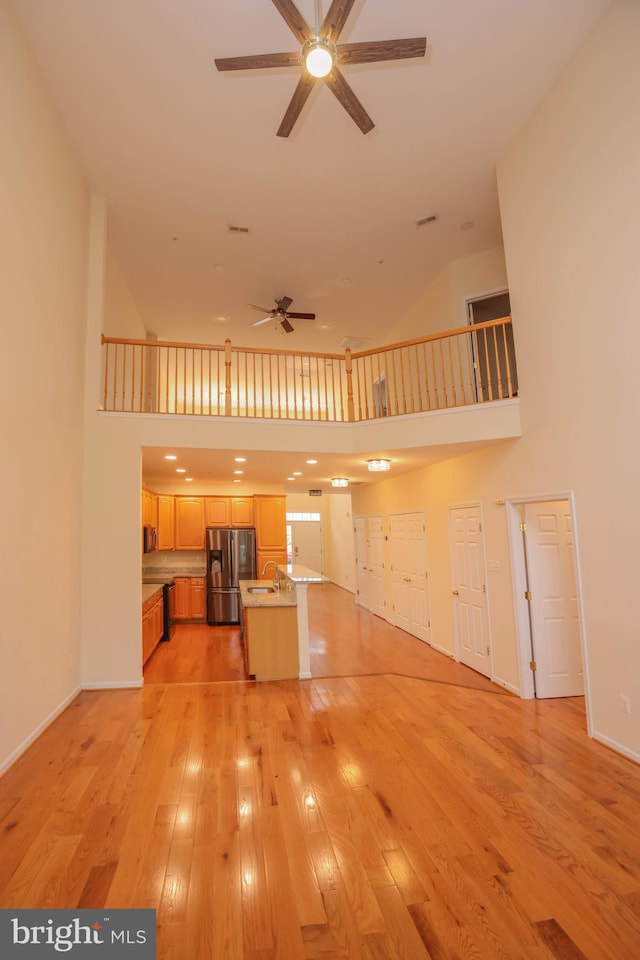 8804 Shining Oceans Way Unit 53, Columbia, MD 21045 - unfurnished living room with a ceiling fan, high vaulted ceiling, and light wood-style floors