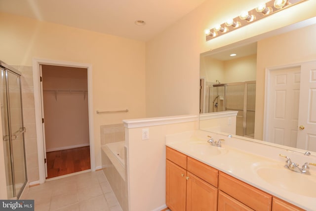 8804 Shining Oceans Way Unit 53, Columbia, MD 21045 - bathroom featuring a shower stall, double vanity, tile patterned floors, a bath, and a spacious closet