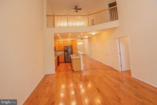 8804 Shining Oceans Way Unit 53, Columbia, MD 21045 - unfurnished living room with ceiling fan, light wood finished floors, a towering ceiling, and recessed lighting