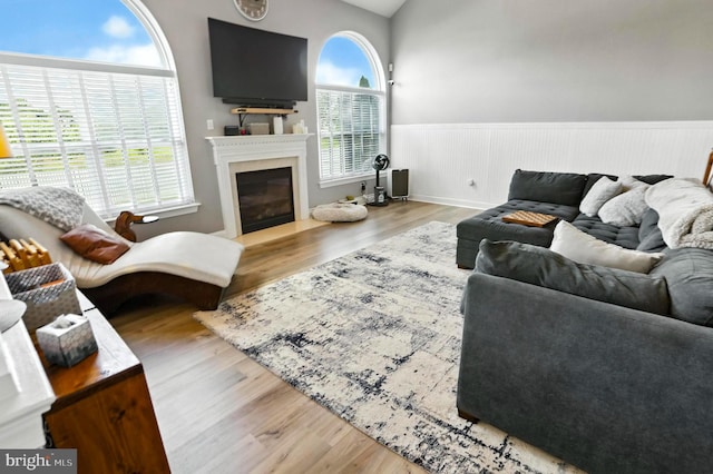 70 Marjessa Dr, Gilbertsville, PA 19525 - living room featuring a wainscoted wall, a glass covered fireplace, and wood finished floors
