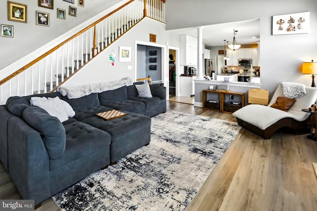 70 Marjessa Dr, Gilbertsville, PA 19525 - living area featuring wood finished floors, stairs, and decorative columns