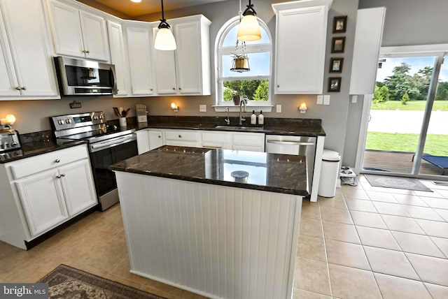 70 Marjessa Dr, Gilbertsville, PA 19525 - kitchen with appliances with stainless steel finishes, white cabinetry, light tile patterned floors, a center island, and hanging light fixtures