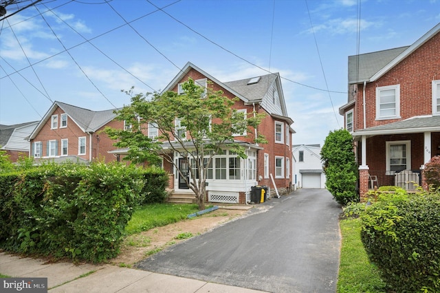 208 Edgemont Ave, Ardmore, PA 19003 - view of front facade with an outdoor structure, brick siding, and a garage