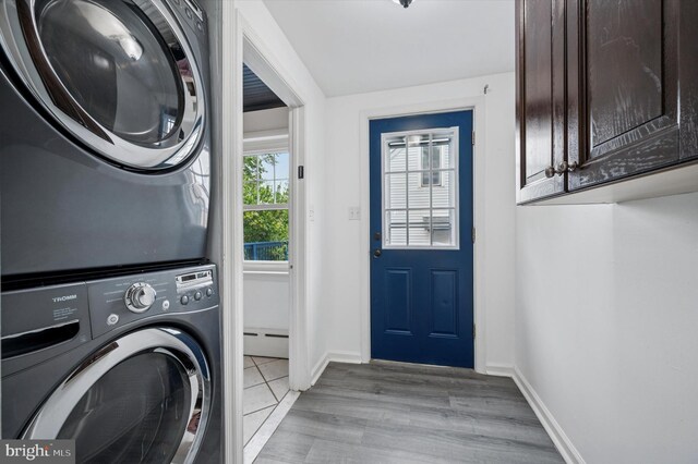 208 Edgemont Ave, Ardmore, PA 19003 - washroom featuring stacked washer / dryer, cabinet space, a baseboard radiator, and light wood-type flooring