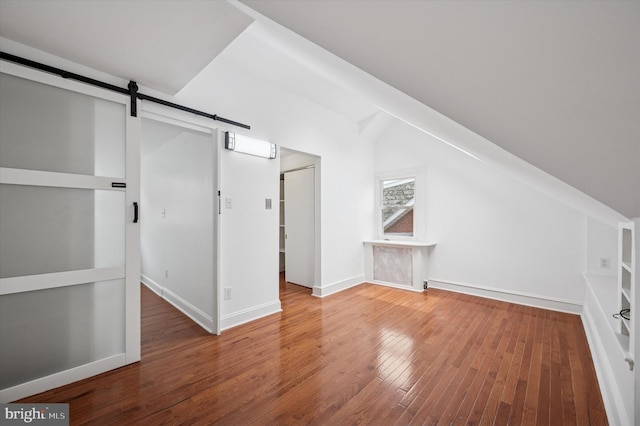 208 Edgemont Ave, Ardmore, PA 19003 - additional living space featuring wood finished floors, a barn door, and lofted ceiling
