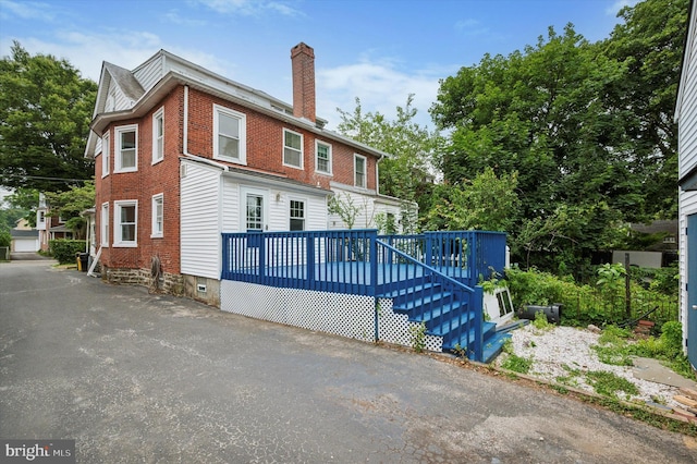 208 Edgemont Ave, Ardmore, PA 19003 - view of front of home featuring a chimney, a wooden deck, and brick siding