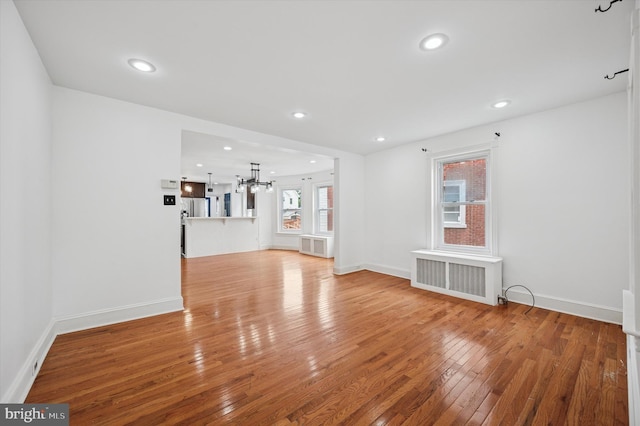 208 Edgemont Ave, Ardmore, PA 19003 - unfurnished living room featuring radiator, a chandelier, light wood finished floors, and recessed lighting