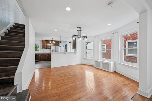 208 Edgemont Ave, Ardmore, PA 19003 - unfurnished living room featuring a chandelier, radiator, stairway, light wood-type flooring, and recessed lighting