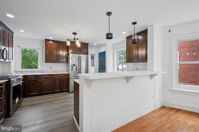 208 Edgemont Ave, Ardmore, PA 19003 - kitchen with stainless steel appliances, light countertops, decorative backsplash, and recessed lighting