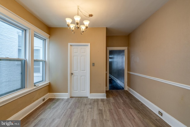 589 N Plum St, Lancaster, PA 17602 - unfurnished dining area featuring wood finished floors and a chandelier