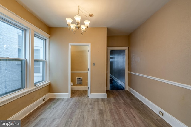 589 N Plum St, Lancaster, PA 17602 - unfurnished dining area with wood finished floors and a chandelier