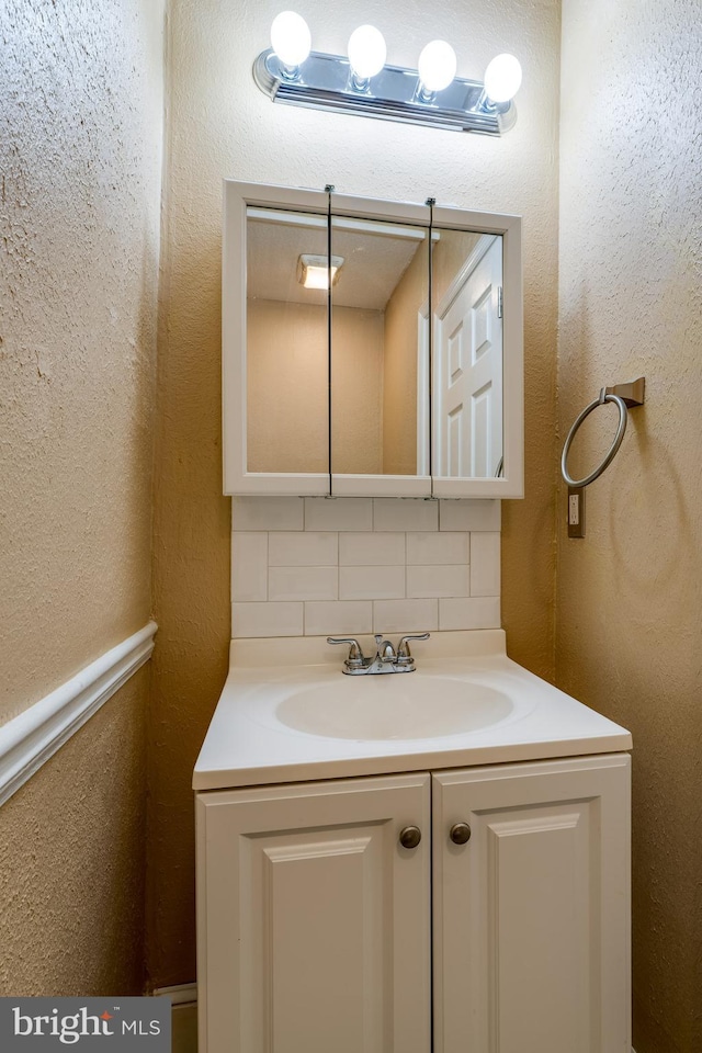 589 N Plum St, Lancaster, PA 17602 - bathroom featuring decorative backsplash and vanity