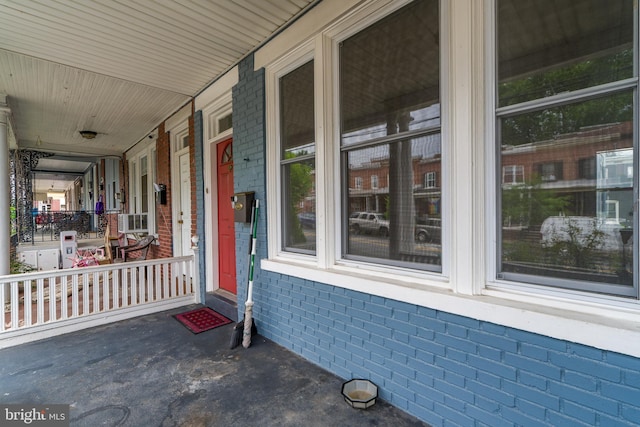 589 N Plum St, Lancaster, PA 17602 - property entrance featuring brick siding, a porch, and cooling unit