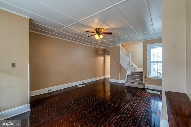 589 N Plum St, Lancaster, PA 17602 - unfurnished living room featuring arched walkways, stairway, hardwood / wood-style floors, and ceiling fan