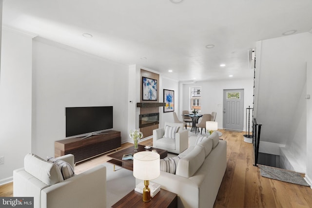 913 E Sanger St, Philadelphia, PA 19124 - living room featuring recessed lighting, light wood-type flooring, and ornamental molding