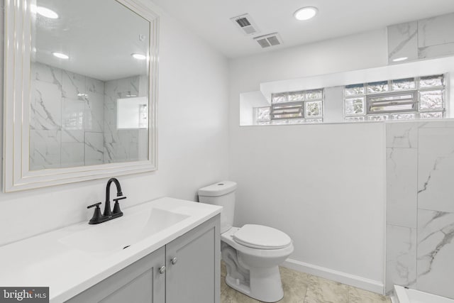 913 E Sanger St, Philadelphia, PA 19124 - bathroom featuring vanity, marble look tiles, a marble finish shower, and recessed lighting