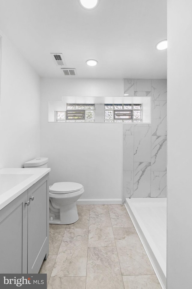 913 E Sanger St, Philadelphia, PA 19124 - bathroom featuring marble look tile flooring, vanity, a marble finish shower, and recessed lighting
