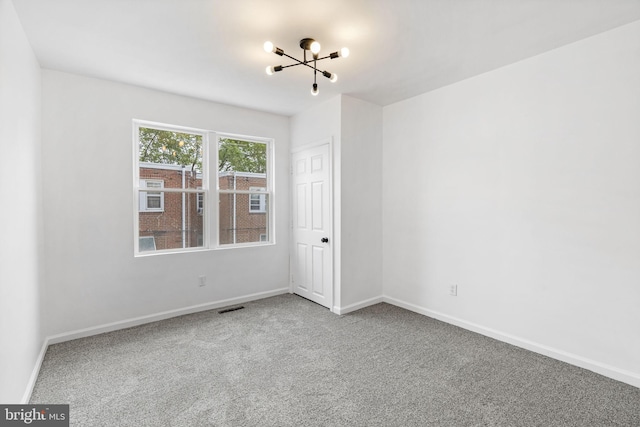 913 E Sanger St, Philadelphia, PA 19124 - spare room with a chandelier and carpet floors