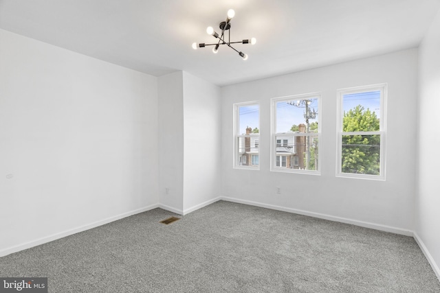 913 E Sanger St, Philadelphia, PA 19124 - carpeted empty room featuring a chandelier and baseboards