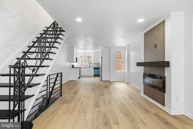 913 E Sanger St, Philadelphia, PA 19124 - unfurnished living room featuring light wood-style floors, stairway, crown molding, and recessed lighting