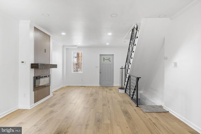 913 E Sanger St, Philadelphia, PA 19124 - unfurnished living room featuring ornamental molding, light wood-style floors, stairway, and recessed lighting