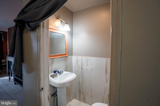 2507 Nicholas St, Philadelphia, PA 19121 - half bath with a wainscoted wall and wood finished floors