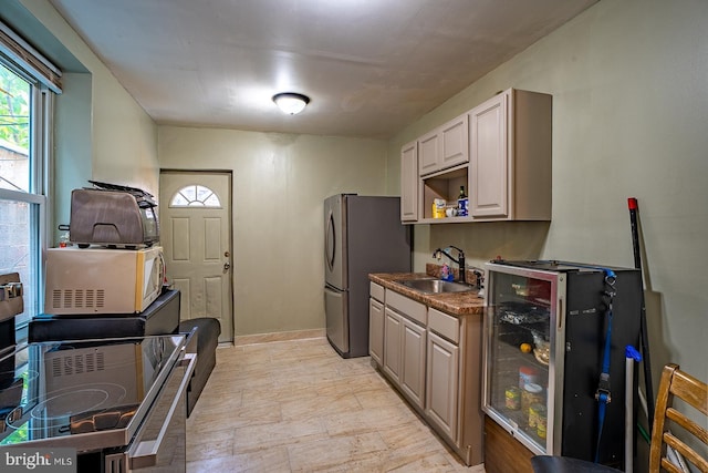 2507 Nicholas St, Philadelphia, PA 19121 - kitchen with freestanding refrigerator, white microwave, and beverage cooler