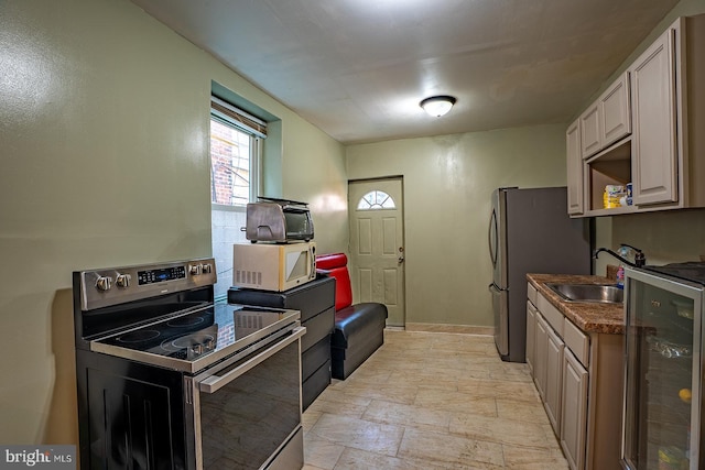 2507 Nicholas St, Philadelphia, PA 19121 - kitchen with stainless steel range with electric cooktop, white microwave, beverage cooler, and light stone finish floors